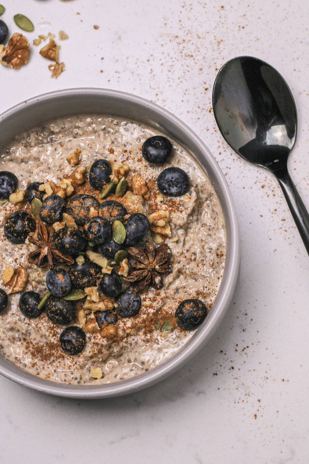Quinoa porridge in a bowl with berries and nuts