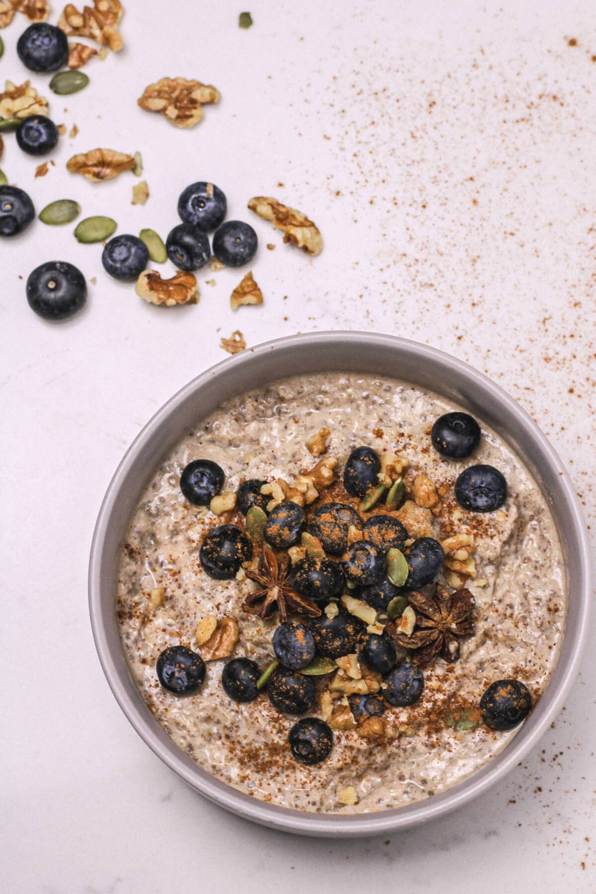 Quinoa porridge in a bowl with berries and nuts