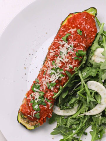 stuffed zucchini and arugula salad on a plate